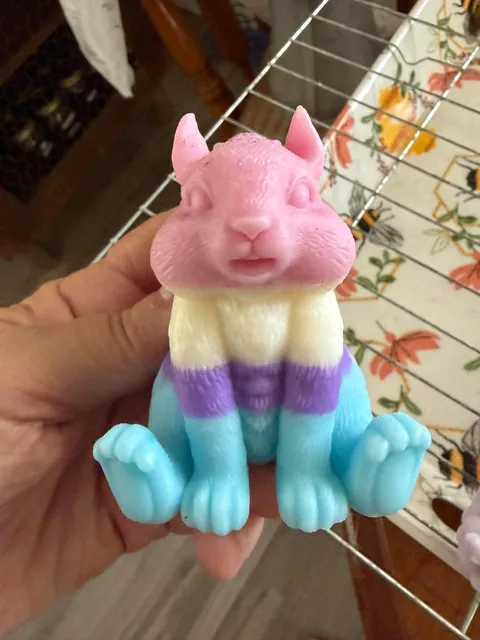 Pink and blue animal-shaped soap held for a closer look