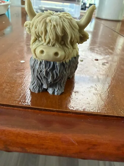 Highland cow-shaped soap on a wooden table